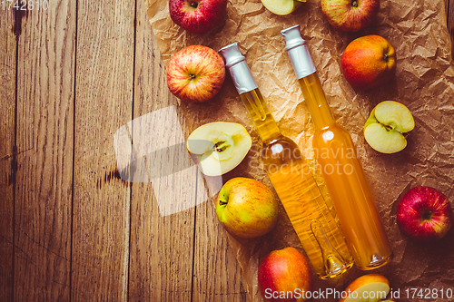 Image of Apple juice with apple vinegar in bottles and fresh apples