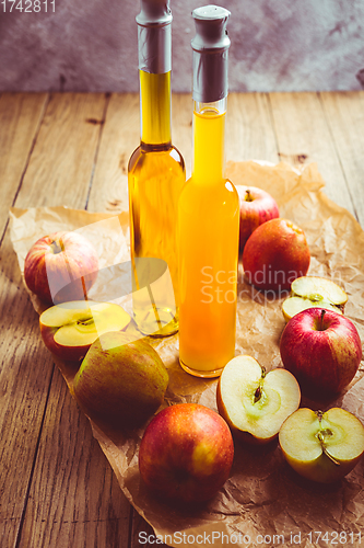 Image of Apple juice with apple vinegar in bottles and fresh apples