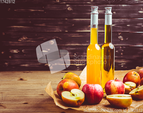 Image of Apple juice with apple vinegar in bottles and fresh apples