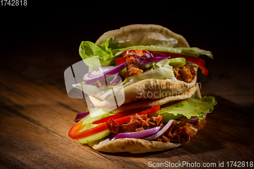 Image of Homemade flatbread sandwich, kebab or doner with chicken meat, lettuce and vegetables