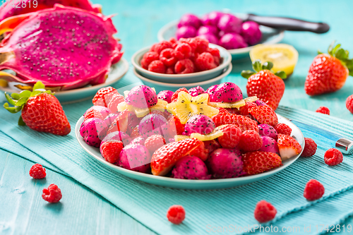 Image of Fresh dragon fruit salad with strawberries, rspberries and start fruit (carambola)