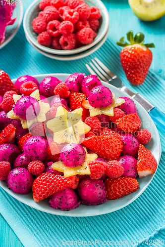 Image of Fresh dragon fruit salad with strawberries, rspberries and start fruit (carambola)