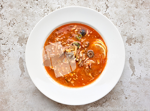 Image of portion of tomato soup with sausage and olives