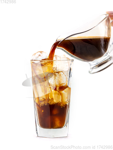 Image of coffee pouring into glass of ice