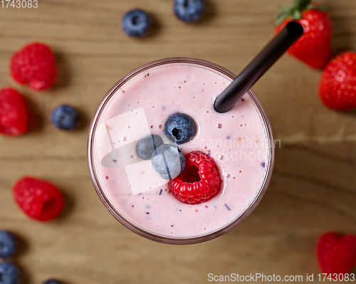 Image of glass of fresh banana and berry milkshake