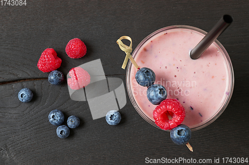 Image of glass of fresh banana and berry milkshake