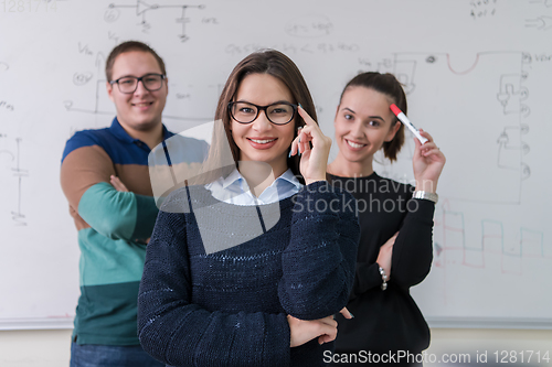 Image of portrait of young students in front of chalkboard