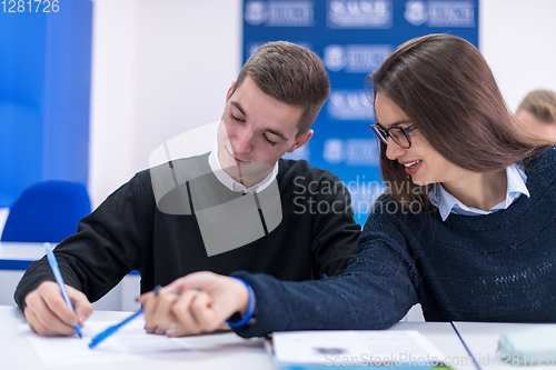 Image of young students writing notes