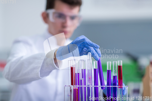 Image of student with protective glasses making chemistry experiment