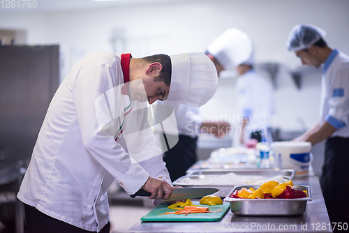 Image of Chef cutting fresh and delicious vegetables