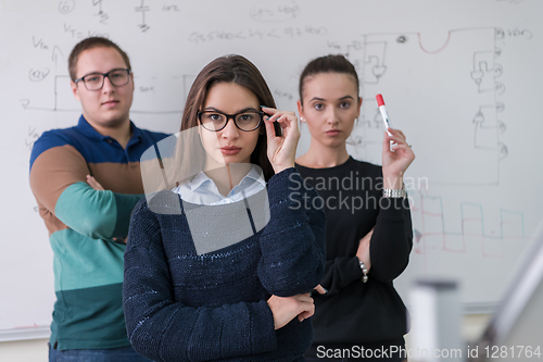 Image of portrait of young students in front of chalkboard