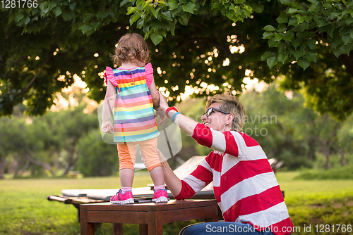 Image of mom and her little daughter using tablet computer