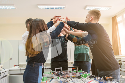 Image of students celebrating successfully finished project