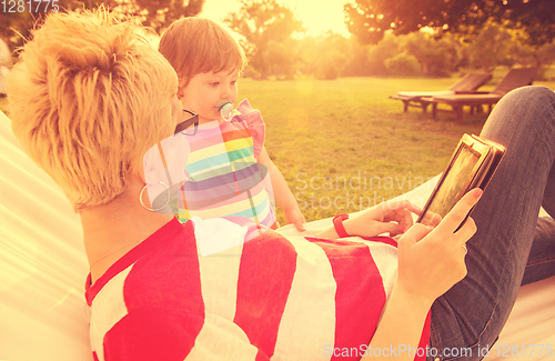 Image of mom and a little daughter relaxing in a hammock