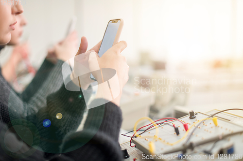 Image of female student using a mobile phone