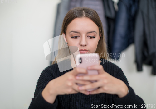 Image of female student using a mobile phone