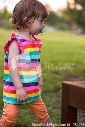 Image of little girl spending time at backyard