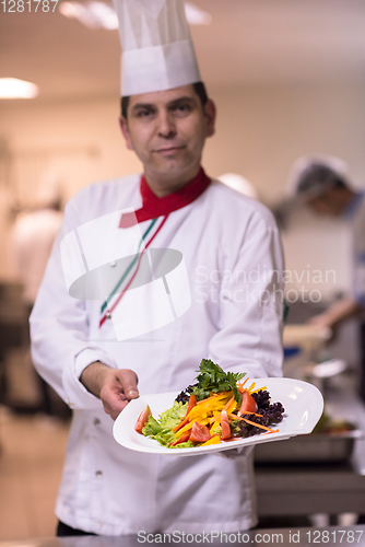 Image of Chef showing a plate of tasty meal