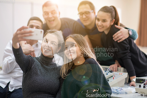 Image of young happy students doing selfie picture