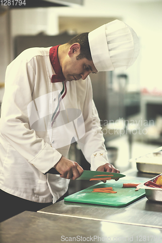 Image of Chef cutting fresh and delicious vegetables