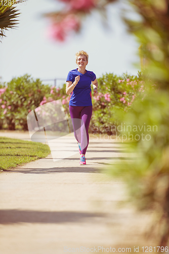 Image of young female runner training for marathon