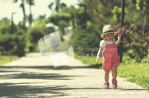 Image of little girl runing in the summer Park