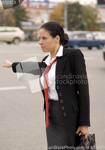 Image of hitchhiking businesswoman 