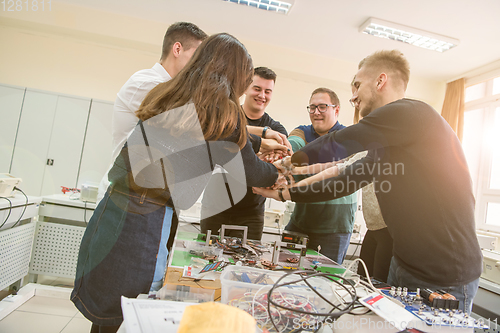 Image of students celebrating successfully finished project