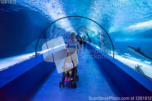 Image of happy family  in the underwater aquarium