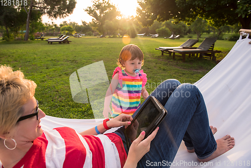 Image of mom and a little daughter relaxing in a hammock