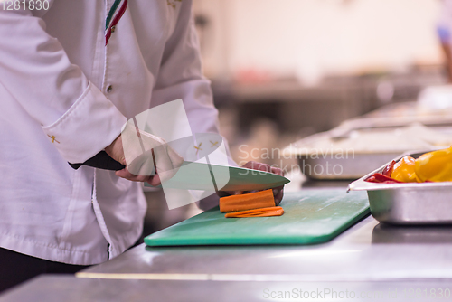 Image of Chef hands cutting fresh and delicious vegetables