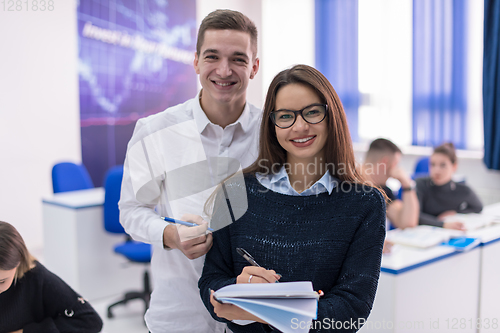 Image of young students writing notes