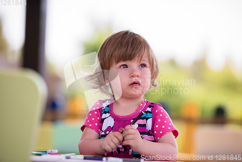 Image of little girl drawing a colorful pictures