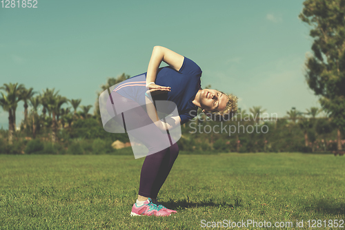 Image of female runner warming up and stretching