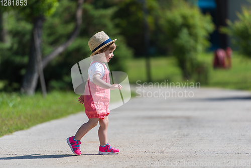 Image of little girl runing in the summer Park