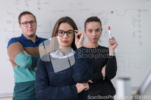 Image of portrait of young students in front of chalkboard