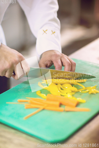 Image of Chef hands cutting fresh and delicious vegetables