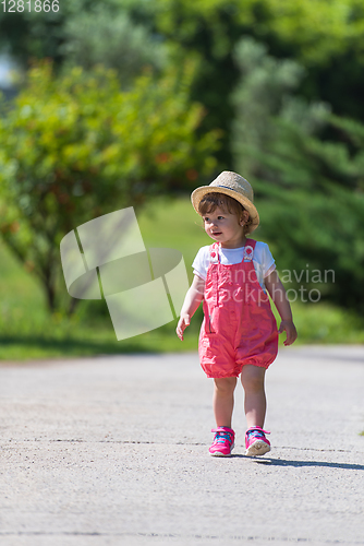 Image of little girl runing in the summer Park