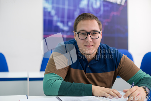 Image of male student writing notes