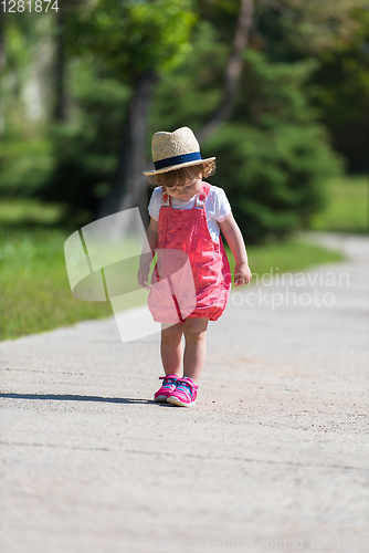 Image of little girl runing in the summer Park