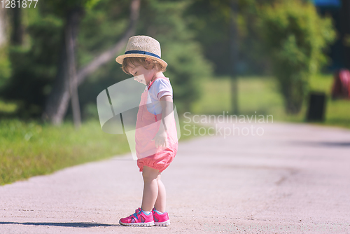 Image of little girl runing in the summer Park