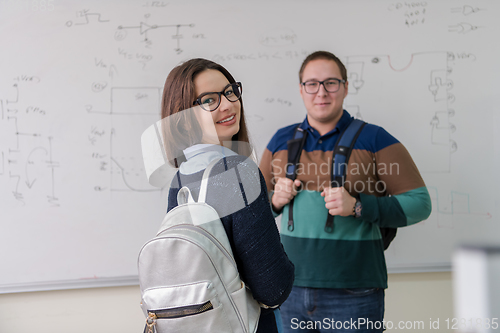 Image of portrait of young students in front of chalkboard