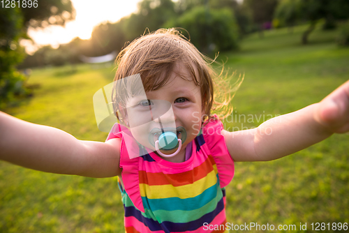 Image of little girl spending time at backyard