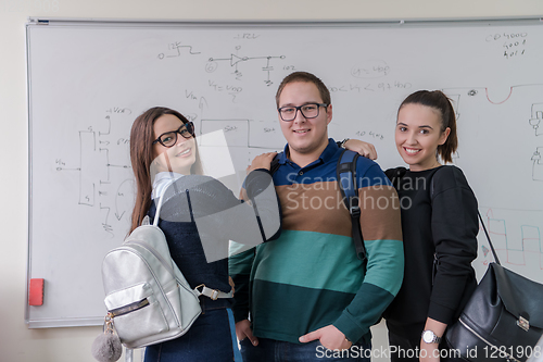 Image of portrait of young students in front of chalkboard