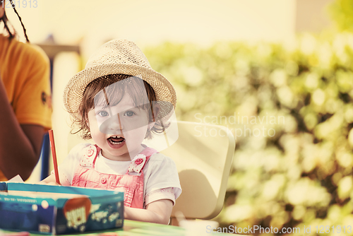 Image of little girl drawing a colorful pictures