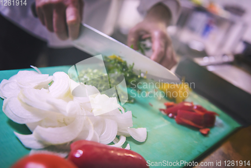Image of Chef hands cutting fresh and delicious vegetables