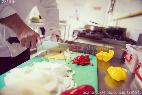 Image of Chef hands cutting fresh and delicious vegetables