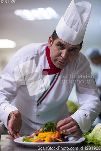 Image of chef serving vegetable salad