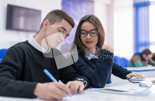 Image of young students writing notes