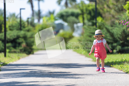 Image of little girl runing in the summer Park